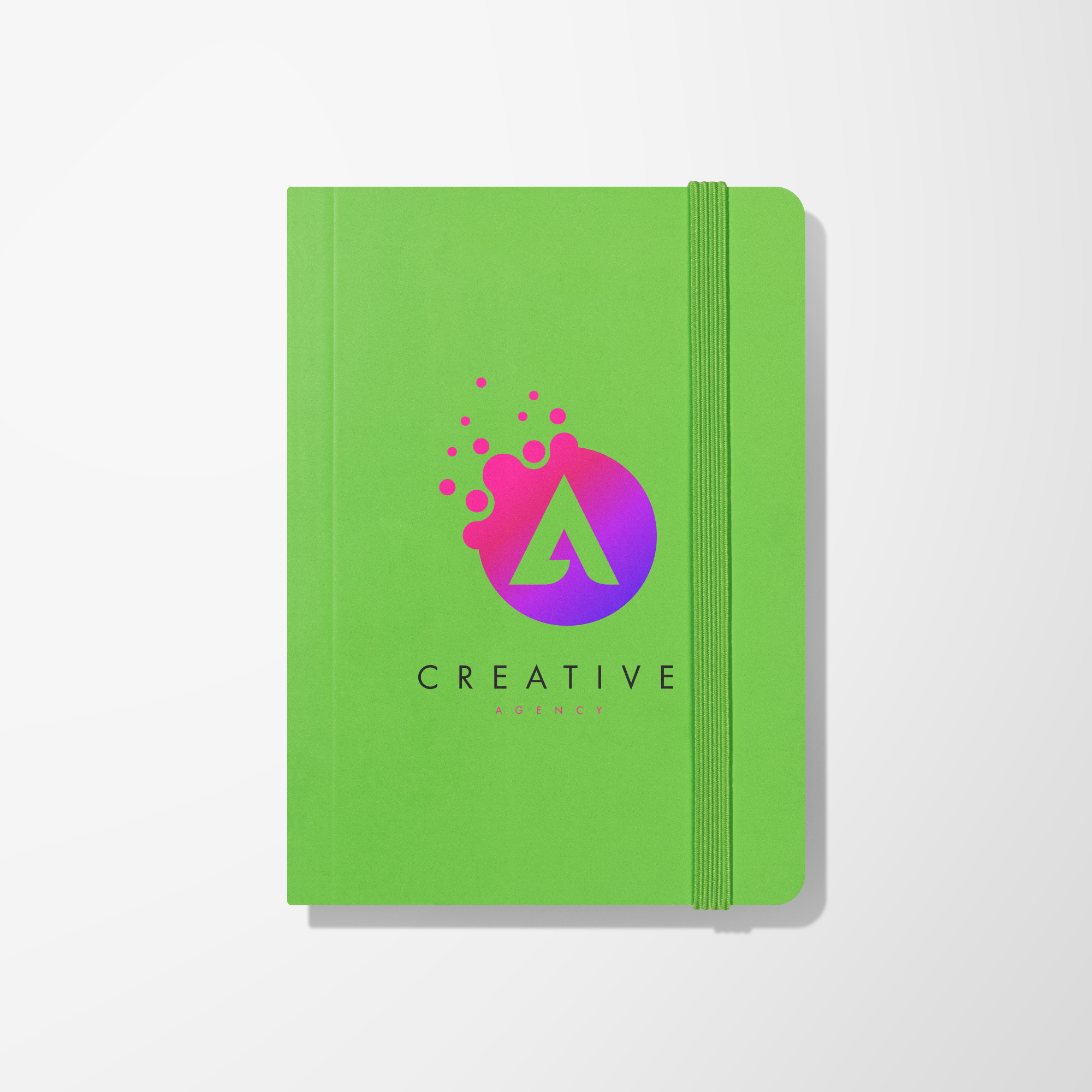 Yellow promotional notebook with pen displaying a white imprint.